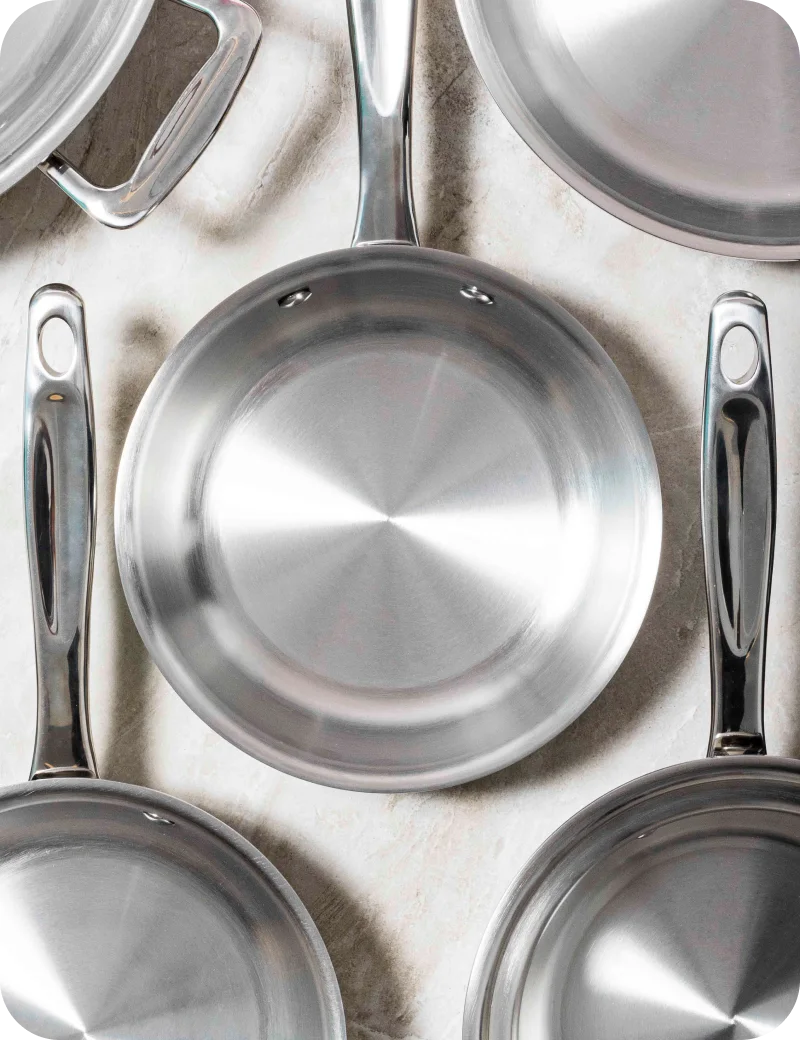 Set of 360cookwares stainless steel cookware on a light background