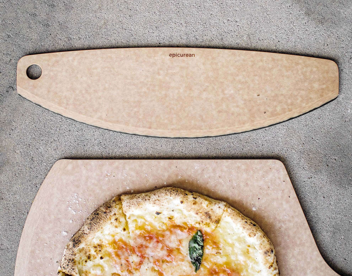 360cookwares pizza cutter on a countertop with a pizza.