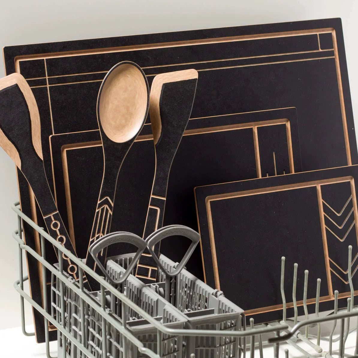 Frank Lloyd Wright Paddle kitchen utensils and cutting boards in a dishwasher rack