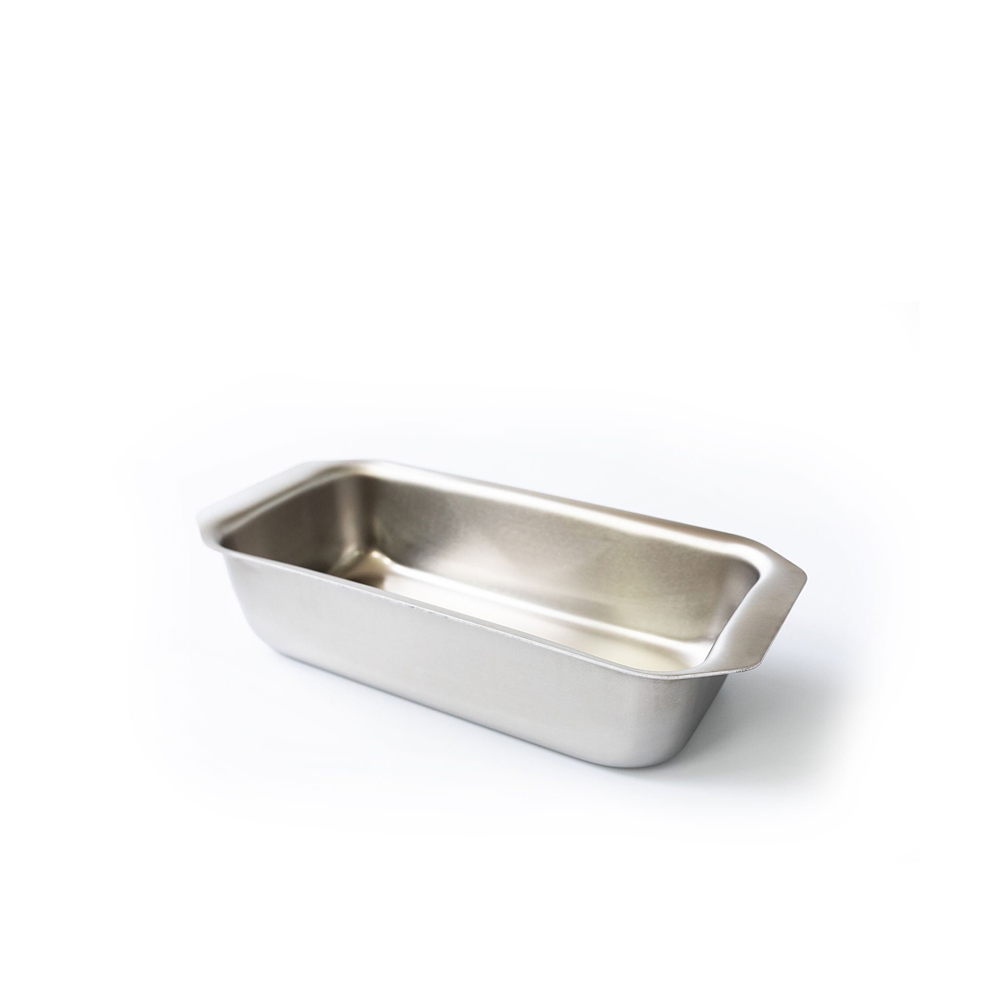 Rectangular stainless steel loaf pan with short handles, empty, angled on white background.