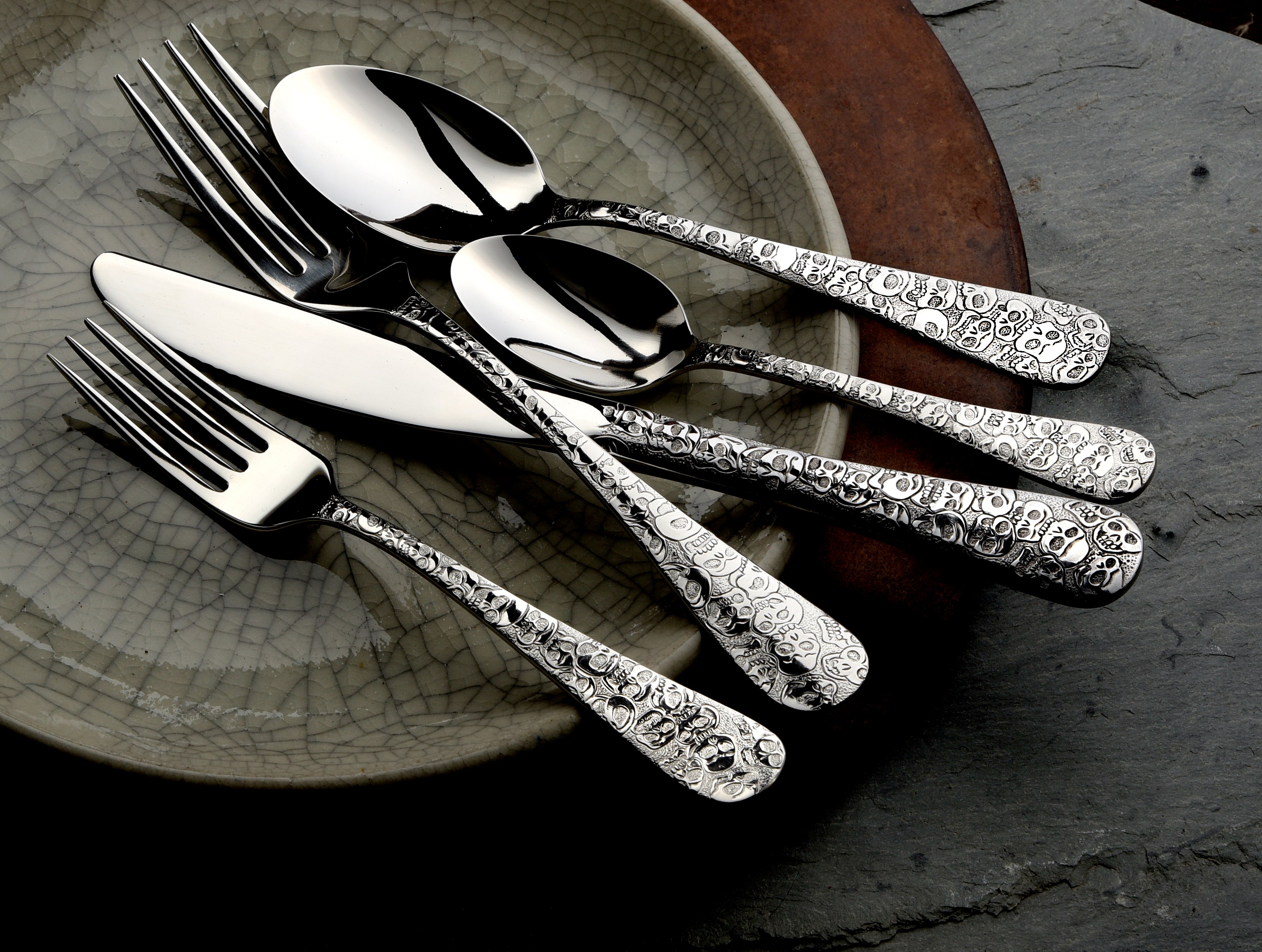 Calavera (Skull) 65 Piece Set featuring ornate silver utensils on a plate