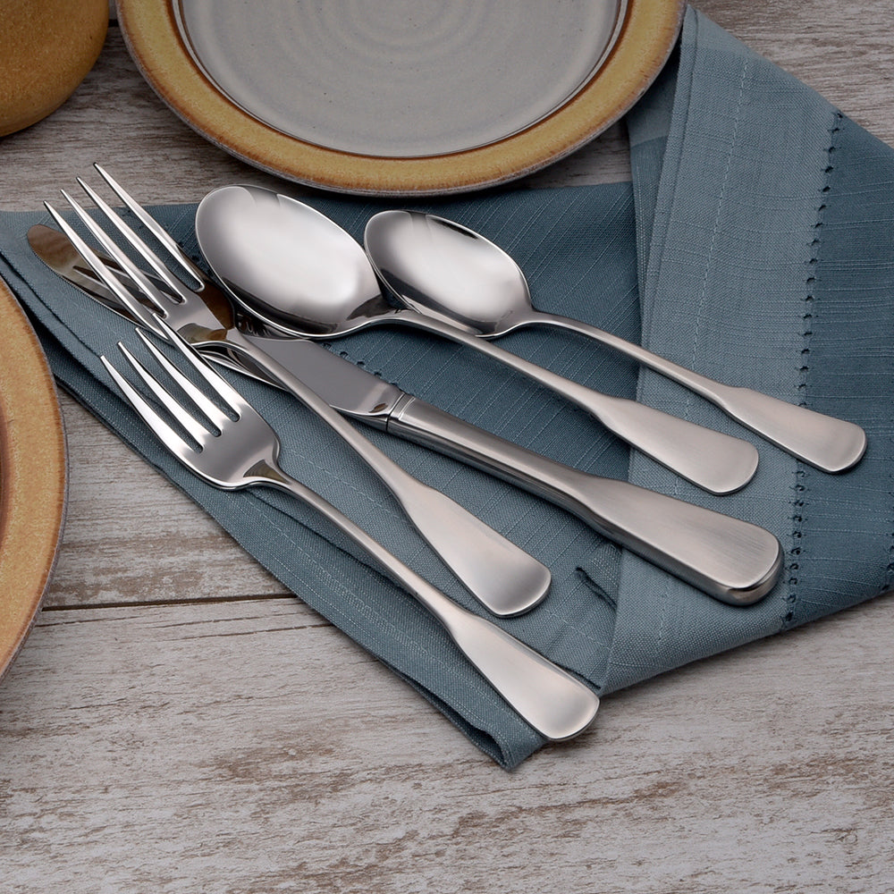 Candra- 65 Piece Set with stainless steel cutlery on a blue napkin