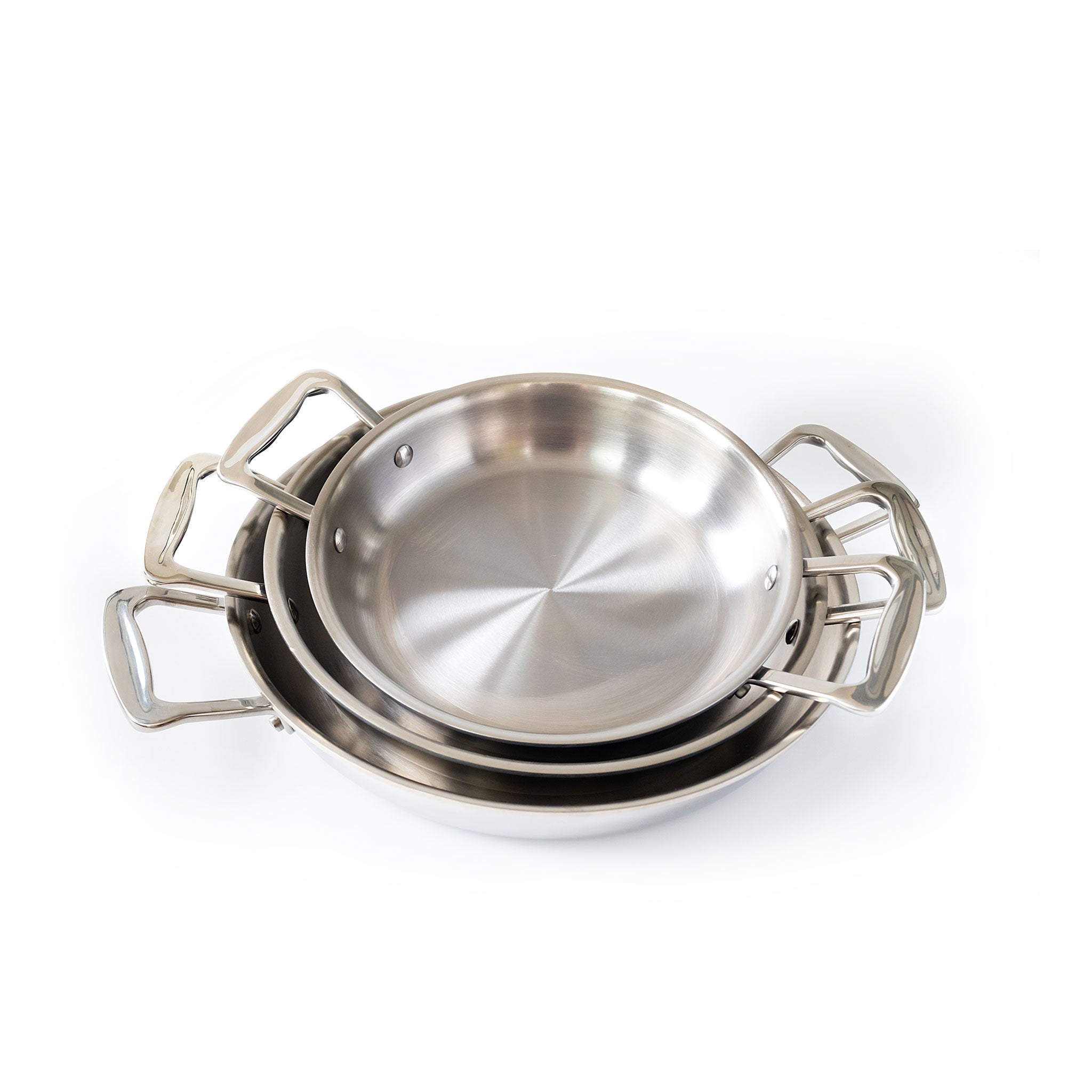Three nested polished stainless steel pans with loop handles, stacked on white background.
