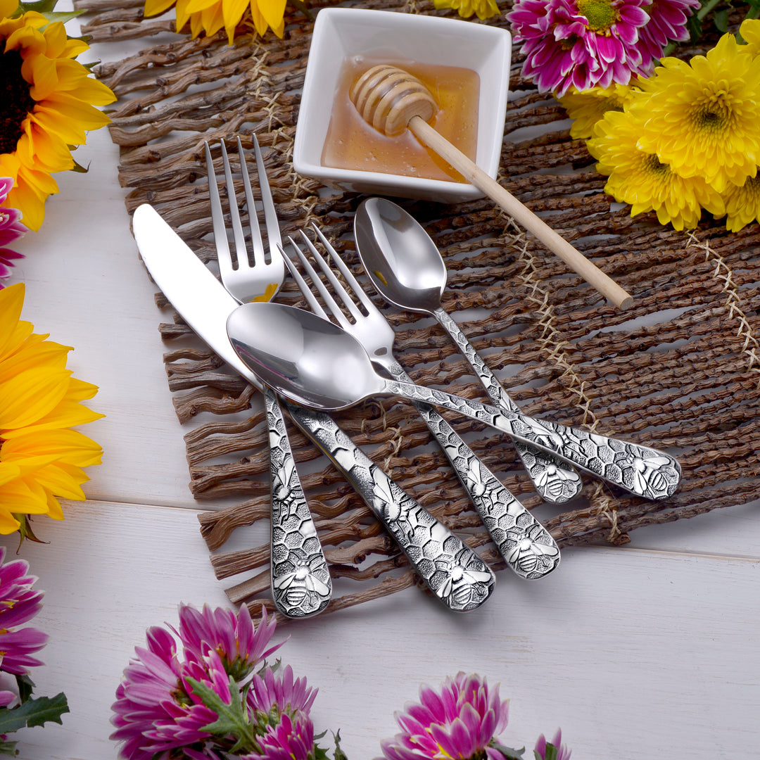 Honey Bee 65 Piece Flatware Set with honey and flowers, featuring bee and honeycomb design
