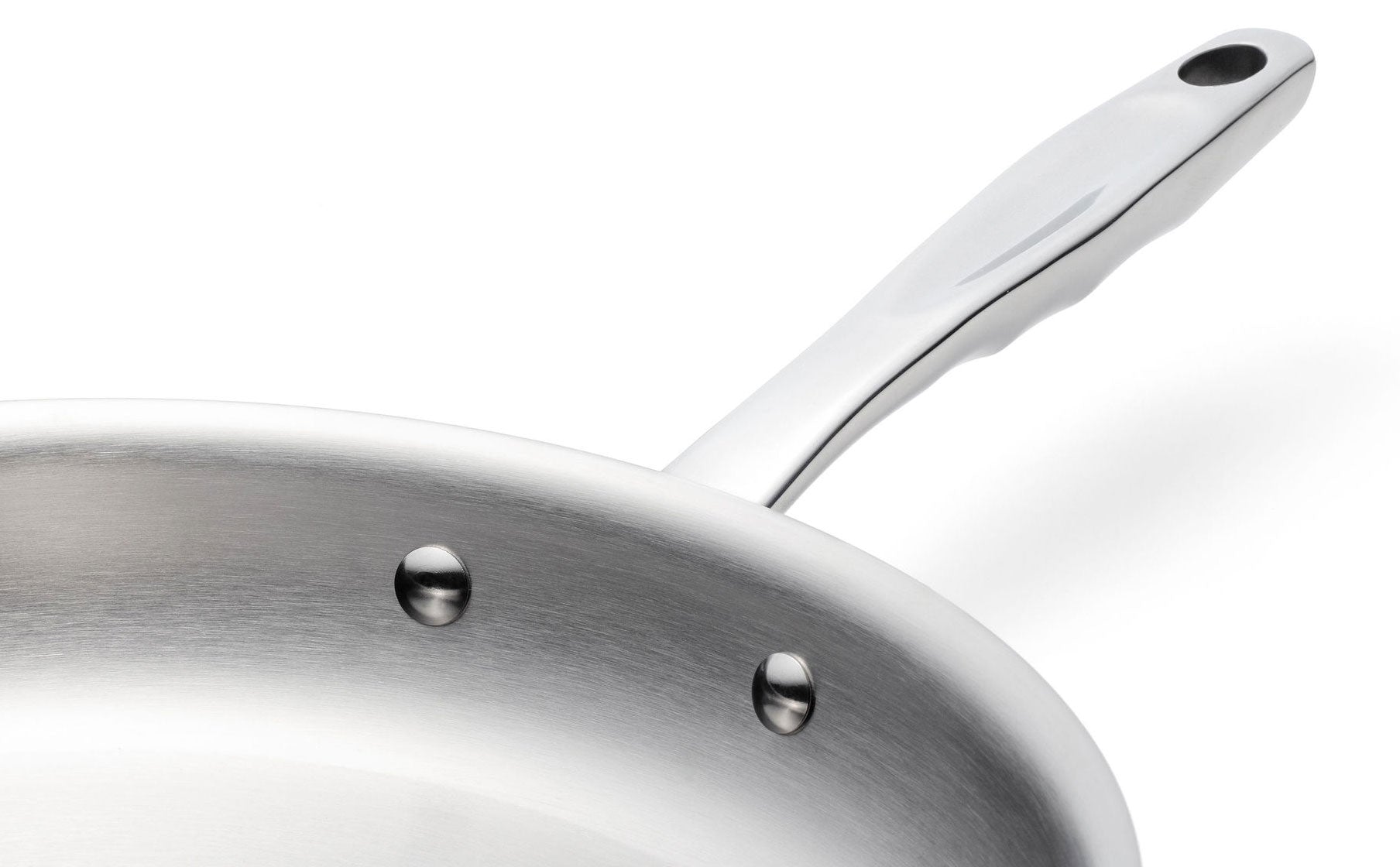 Close-up of a stainless steel 10-inch fry pan handle with rivets